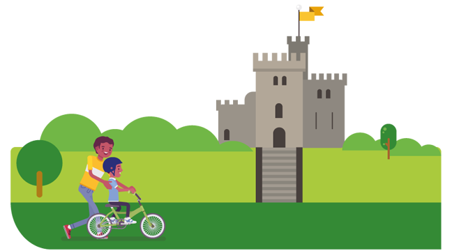 Child riding a bike by Cardiff Castle