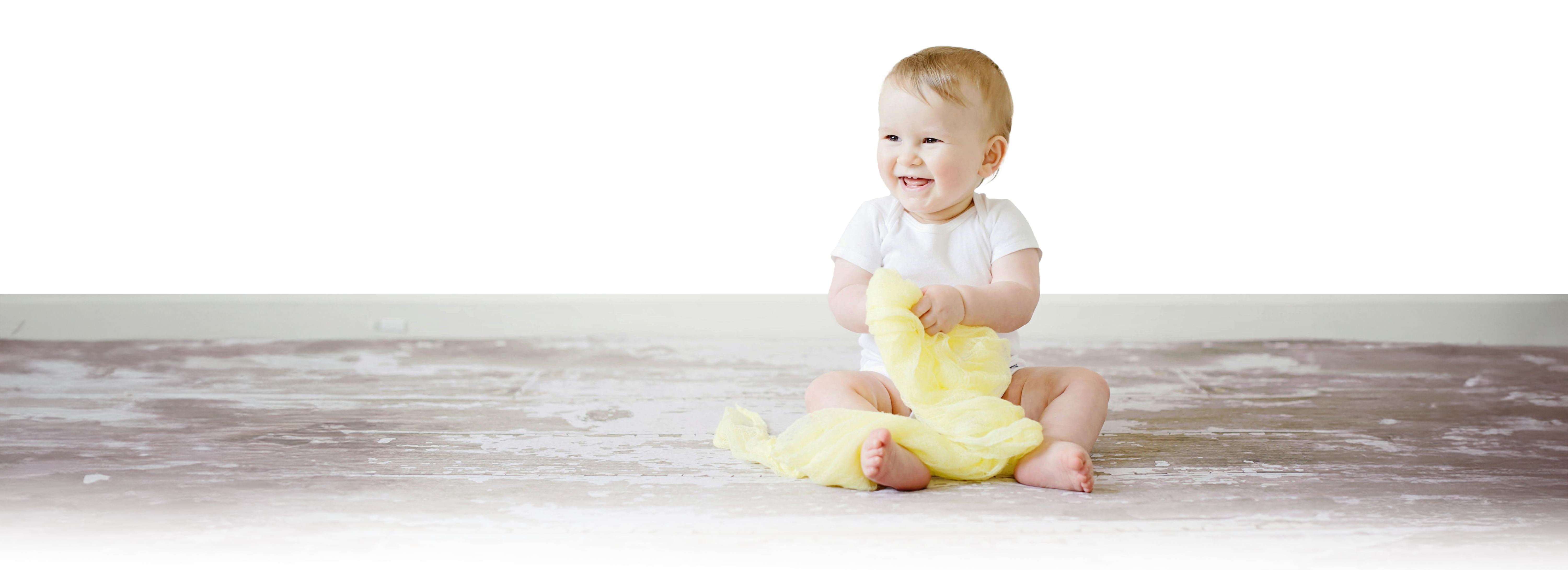 A young baby sat on the floor